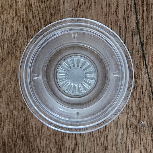 Clear PopGrip addon for Quadlock Rokform adapters on wooden surface