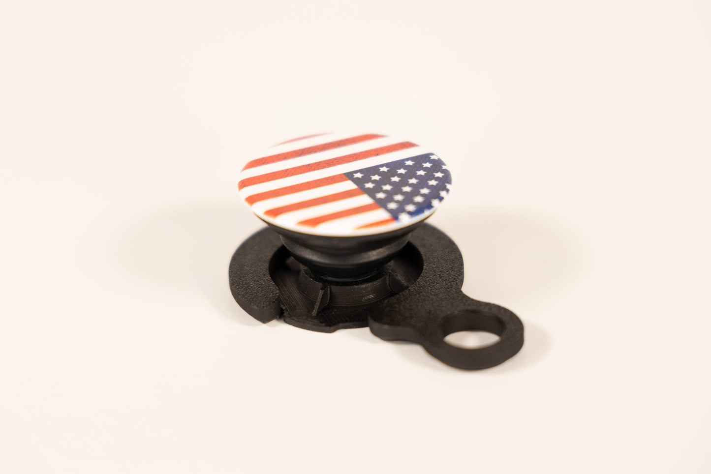 Quadlock PopSocket adapter featuring an American flag design for secure phone mounting