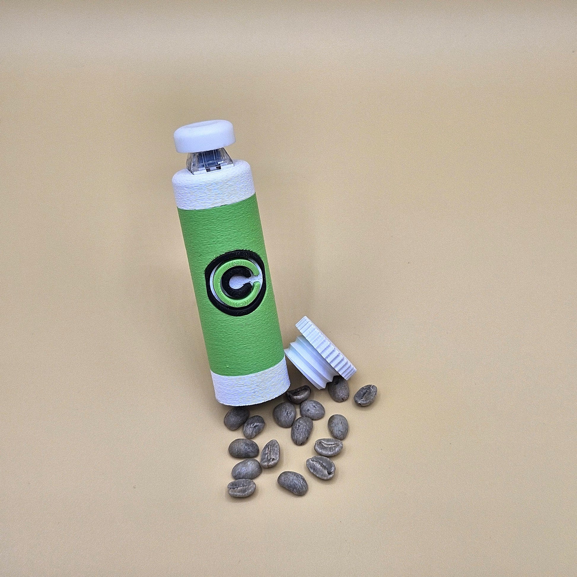 Green and white clicky fidget with storage compartment DBZ and scattered small items on beige background
