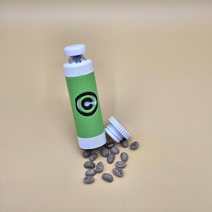 Green and white clicky fidget with storage compartment DBZ and scattered small items on beige background
