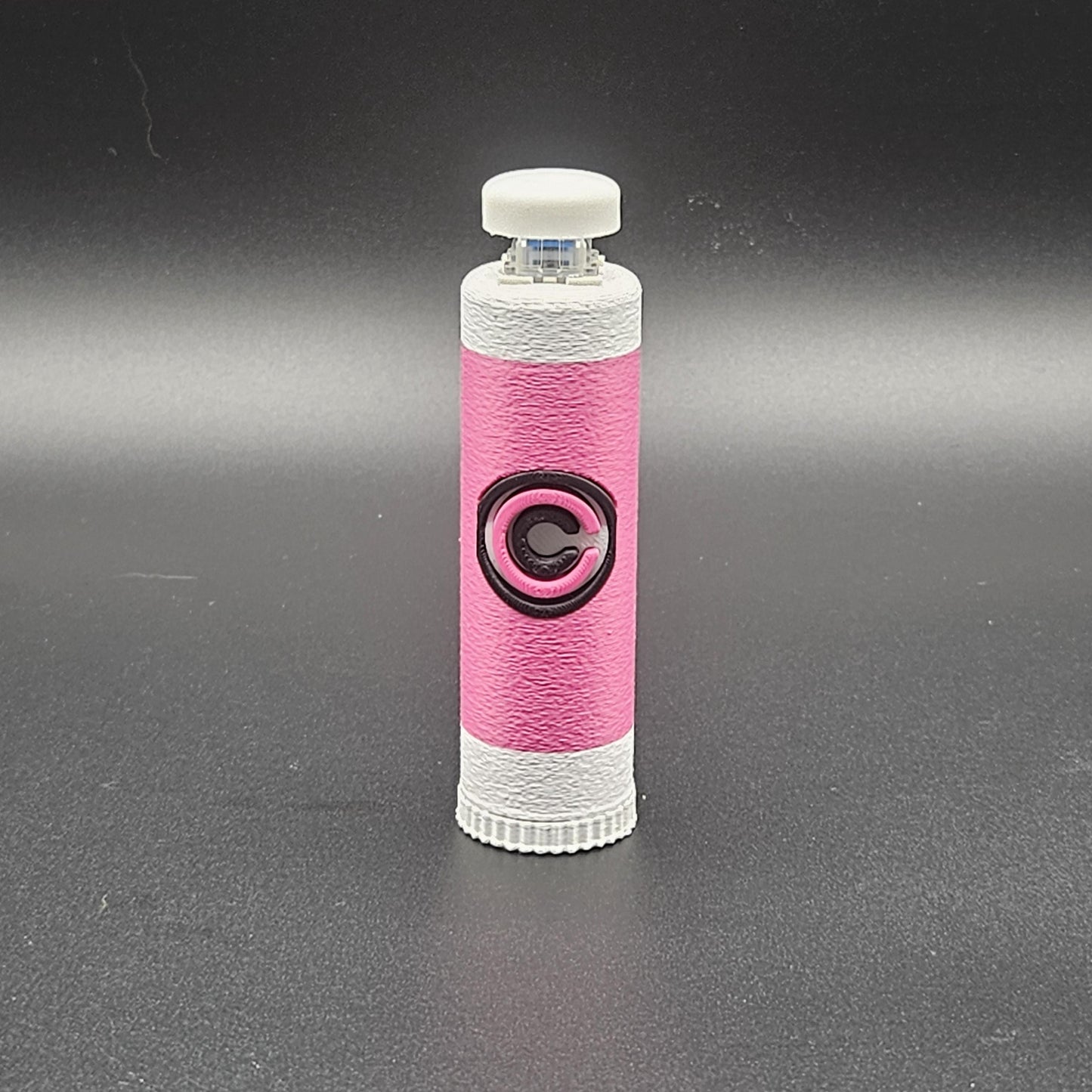 Pink and white clicky fidget with storage compartment DBZ featuring a black Capsule Corp logo
