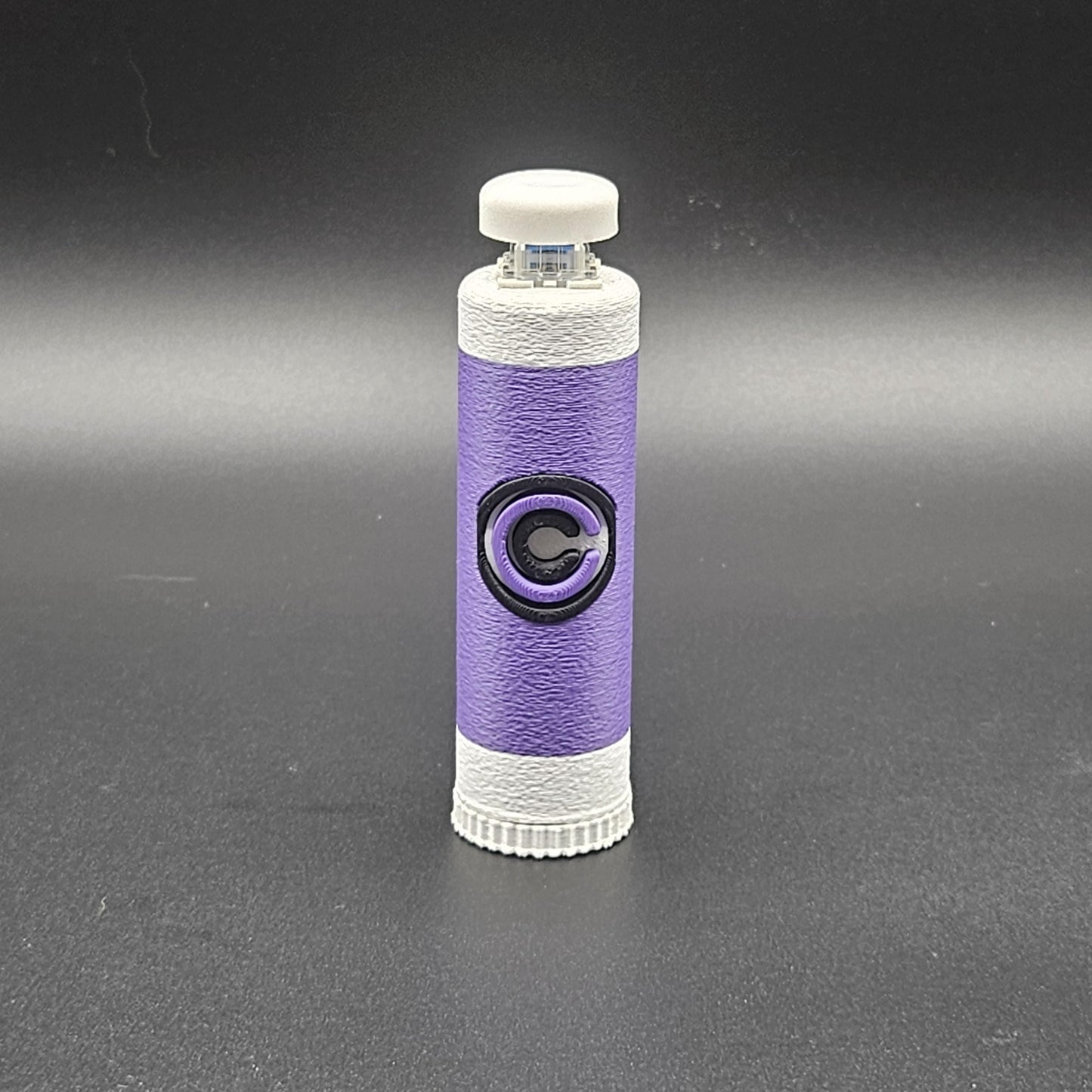 Purple and white clicky fidget with storage compartment DBZ featuring a Capsule Corp logo design