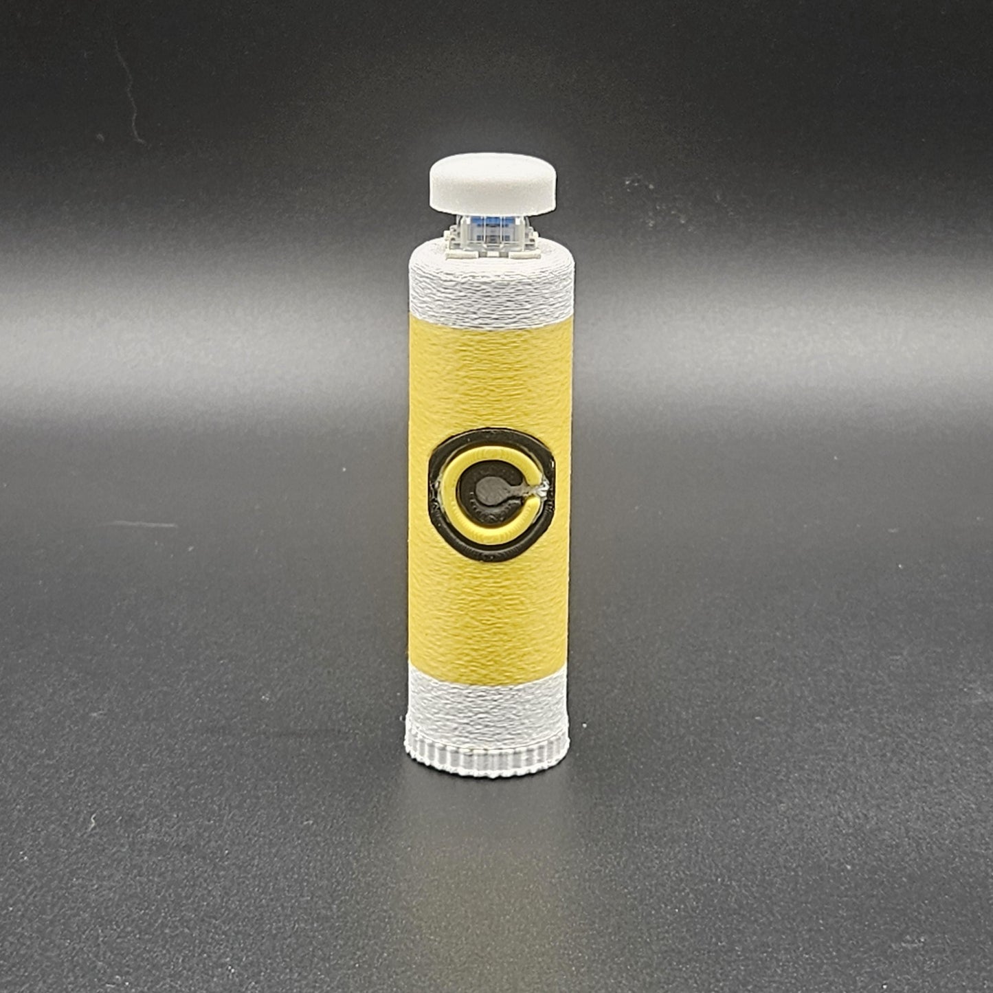 Clicky fidget with storage compartment DBZ in yellow and white with Capsule Corp logo design