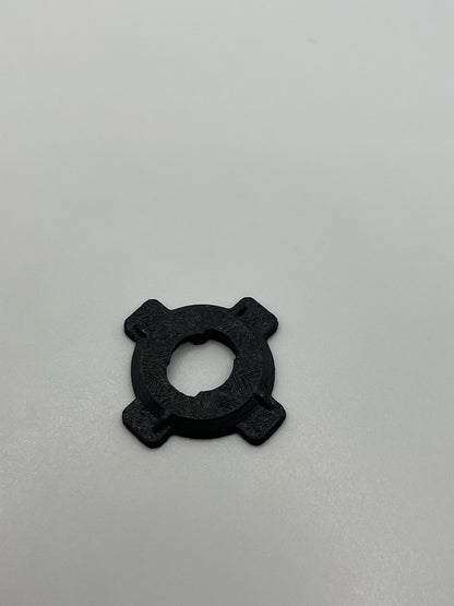 Black Rokform PopSocket adapter with four extended tabs on a white background