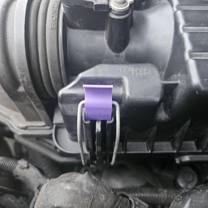 Close-up of 3D printed Honda air cleaner clip in purple attached to black air cleaner housing