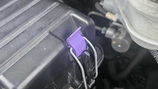 Close-up of 3D printed Honda air cleaner clip securing air filter cover in car engine bay